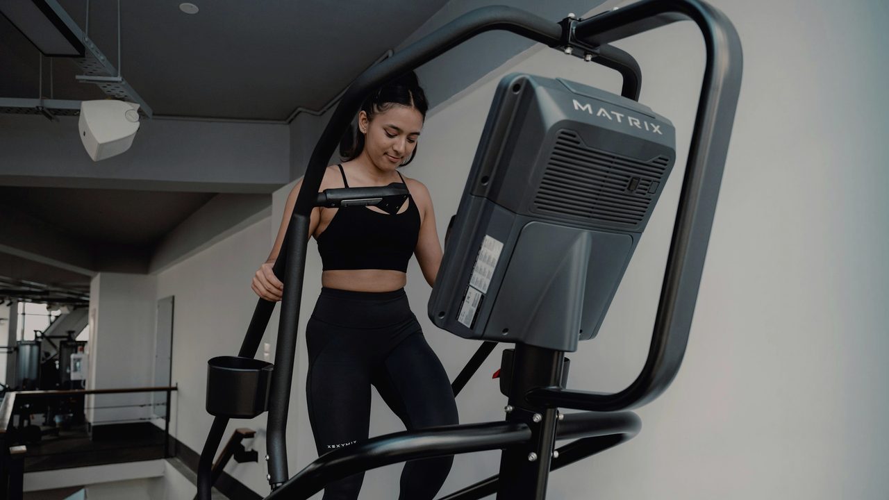 A walker on a consumer treadmill in soft light — Treadmill Edition, the indoor protocol