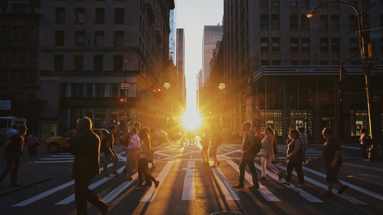 A group of pedestrians walking along a city pedestrian lane.